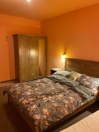 a bedroom with a bed and a wooden cabinet at Když nevíte kam, přijeďte k nám penzion D'Artagnan in Kořenov