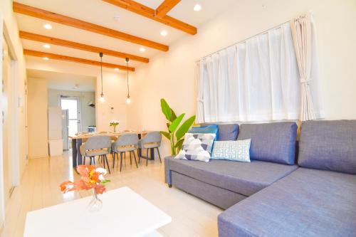 a living room with a couch and a table at KAWAII House -Free Parking- in Osaka
