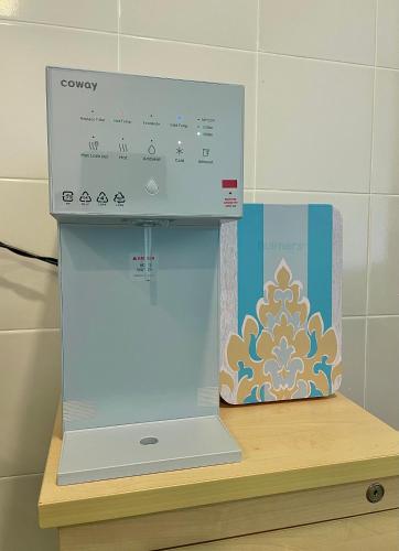 a box sitting on top of a shelf next to a box at Amyra Suite Kuantan in Kuantan