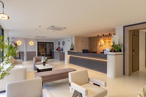 a lobby of a hospital with chairs and a counter at The Bentley Hotel in Bangkok
