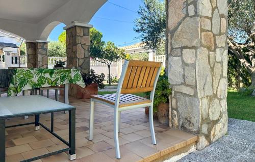 a chair and a table on a patio at 4 Bedroom Lovely Home In Creixell in Roda de Bará