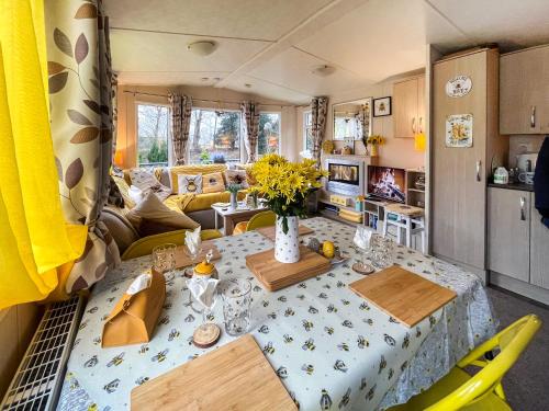 a kitchen and living room with a table and chairs at The Hive in Hawick