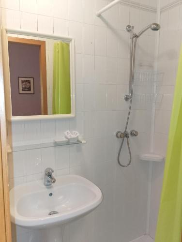 a bathroom with a sink and a shower with a mirror at Locanda da Lucia in Noventa di Piave