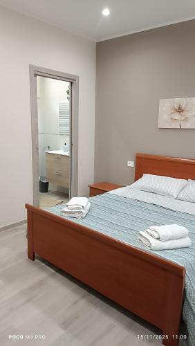 a bedroom with a large bed with towels on it at Grotthouse in Andria
