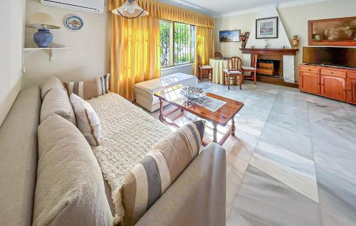 a living room with a couch and a table at 2 Bedroom Beautiful Home In Benalmadena in Benalmadena Costa