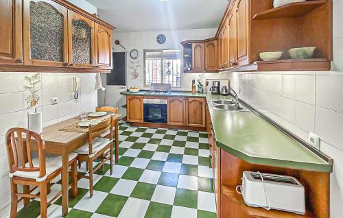 a kitchen with wooden cabinets and a table and chairs at 2 Bedroom Beautiful Home In Benalmadena in Benalmadena Costa