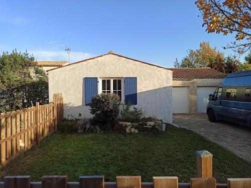 ein Haus mit einem Zaun davor in der Unterkunft Maison de vacances Ile d'Oléron 2 Chambres in Saint-Pierre-dʼOléron