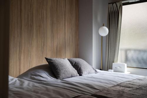 a bedroom with a bed with a laptop on it at Lucky you! SHIBUYA in Tokyo