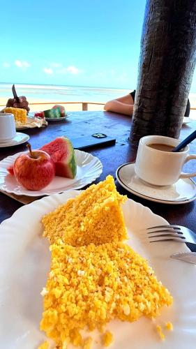 a white plate with a piece of cake on a table at Pousada Ap in Acaraú
