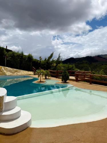 a swimming pool in the middle of a house at Finca cerca a Cali El Paraíso de Salo in Papagalleros