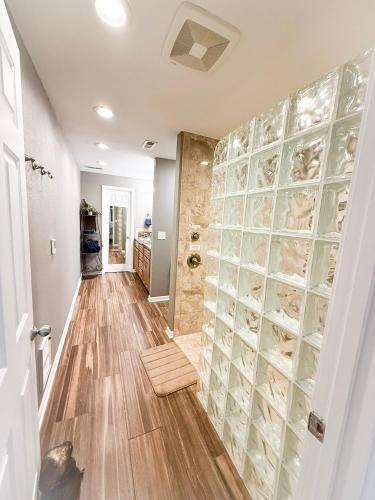 a hallway with a walk in shower with glass doors at Lakefront Home 5BD3BA DockGrillsDeckKayaks-16 in Sunrise Beach
