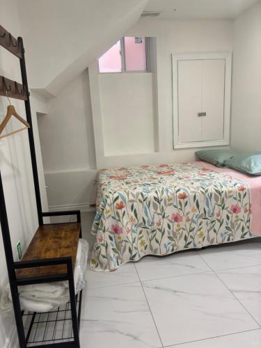 a bedroom with a bed with a floral bedspread at park inn in Toronto