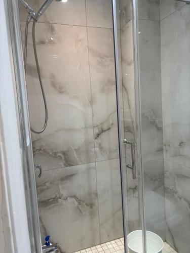 a shower with a glass door and a toilet at park inn in Toronto