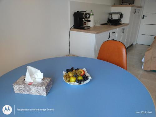 a blue table with a bowl of fruit on it at Casa Albinelor in Braşov