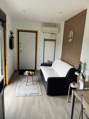 a bedroom with a bed and a table in it at Casinha do codecal in Labruja