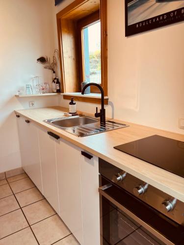 a kitchen with a sink and a counter top at Ferienwohnung Derscheid in Much