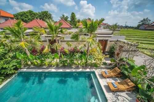 an image of a swimming pool in front of a villa at Puri Canggu Villas & Rooms in Canggu
