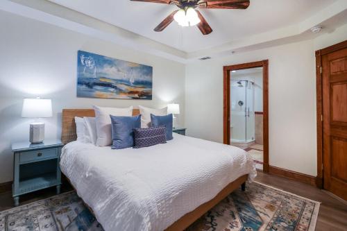 a bedroom with a bed with a ceiling fan at The Vue 233 in Tybee Island