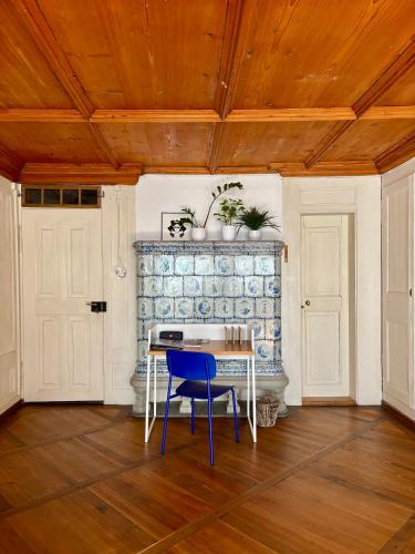 a dining room with a table and a blue chair at Old City Gem-Very Comfy Bed-Bakery Downstairs in Bern