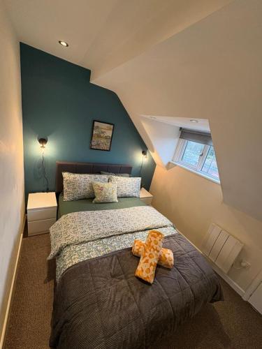 a teddy bear sitting on a bed in a bedroom at #81 Stylish Top Floor - for 2 - 10 mins to Brueton Park - " Perfect for Business Traveler and Couple - Free Parking" in Shirley