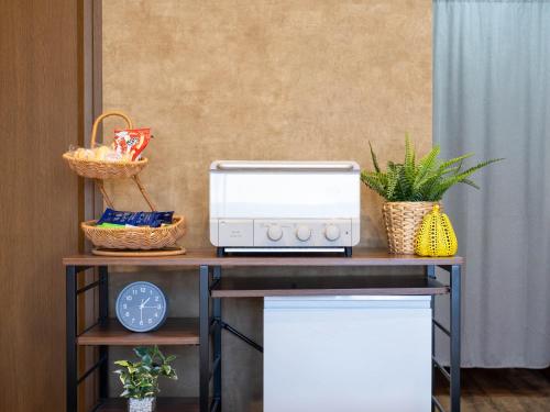 a table with a toaster and a microwave on it at MY STORY Classic 405-瓦町駅徒歩6分 in Shimminatomachi