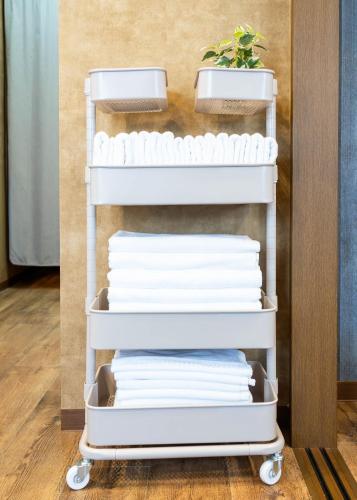 a stack of white towels on a towel rack at MY STORY Classic 405-瓦町駅徒歩6分 in Shimminatomachi