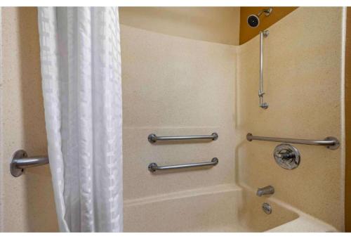 a shower in a bathroom with a shower curtain at Studio 6 Suites Greenville, SC - Haywood Mall in Greenville