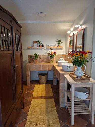 a bathroom with two sinks and two mirrors at Wellness B&B Het Wapserhofje in Wapse