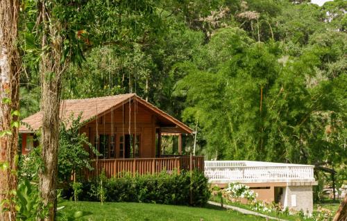 a small house in the middle of a forest at Pousada Ocean Garden in Antonina