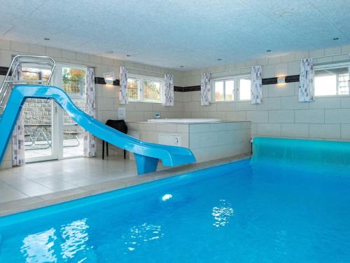 a swimming pool with a blue slide in a house at 5 star holiday home in Ebeltoft in Ebeltoft