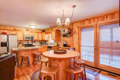 a kitchen with wooden cabinets and a table with bar stools at River Roost in Todd