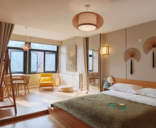 a bedroom with a large bed and a dining room at 寺外茶宿SiWai tea&house-Near Xi' an Bell Tower in Xi'an