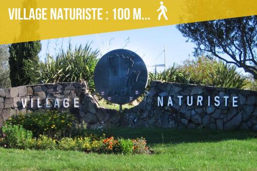 a sign forvillage maritage with a stone wall at Appartement Cap Estivales in Cap d'Agde