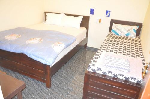 Postel nebo postele na pokoji v ubytování Ayodhya Guest House