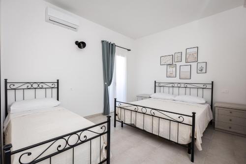 Ένα ή περισσότερα κρεβάτια σε δωμάτιο στο Le Dimore di Nonna Nina