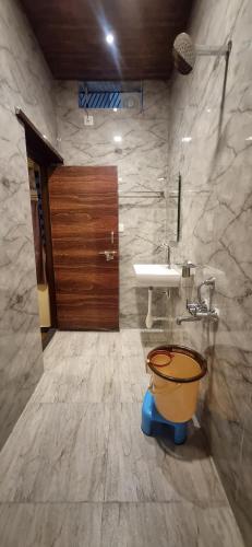 a bathroom with a sink and a toilet at Ayodhya Guest House in Hampi