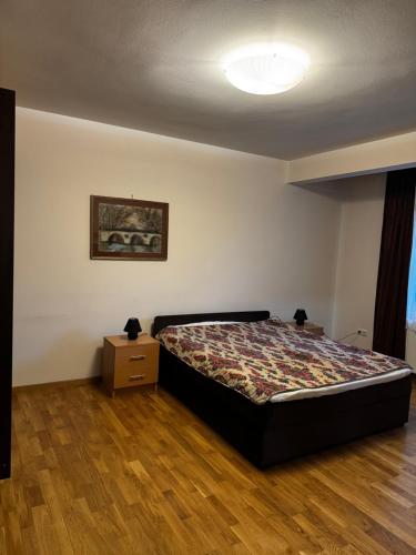 a bedroom with a bed and a wooden floor at Old Town 33 in Sarajevo