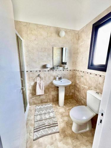a bathroom with a toilet and a sink at Casa Elea in Kouklia