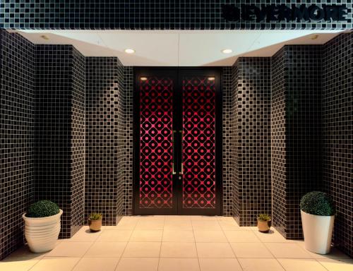 a door with a bunch of red hearts on it at HOTEL EVERMORE -Adult Only- in Hirosaki