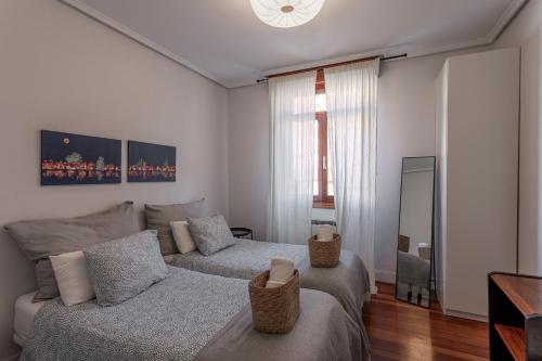 a bedroom with a bed and a couch at New Bilbao city center in Bilbao