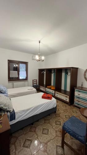 a large bedroom with two beds and a table at B&B Angelo e Graziella in Monterosi