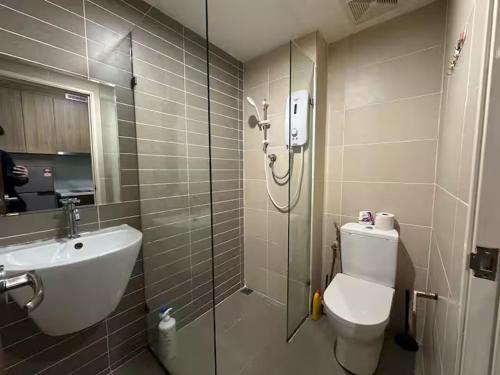a bathroom with a shower and a toilet and a sink at Cozy Stays Studio - Kozi Square Kuching in Kuching