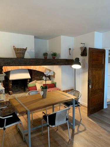 a dining room with a table and chairs and a fireplace at I CARCIONI Infinity Pool in Belgirate