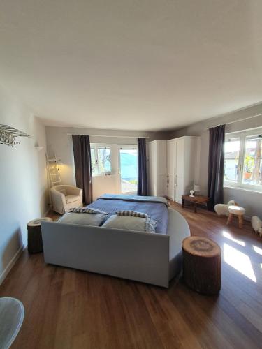 a large bedroom with a large bed and wooden floors at I CARCIONI Infinity Pool in Belgirate