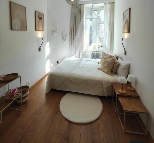 a bedroom with a white bed and a window at Cozy small apartment in Vienna