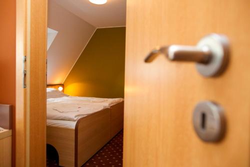 a door to a bedroom with a bed in a room at Hotel Zámek Berchtold in Kunice - Vidovice