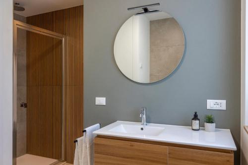 a bathroom with a sink and a mirror at Casa Vistalago Mountain Lake Iseo Hospitality in Bossico