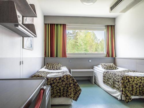 a room with two beds and a window at Hotel Nuuksio - Conferences and events in Espoo