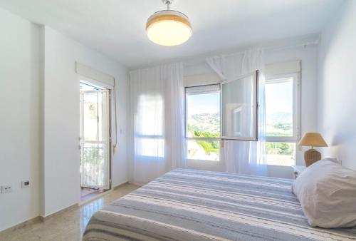 En eller flere senge i et værelse på Casa Los Pinos