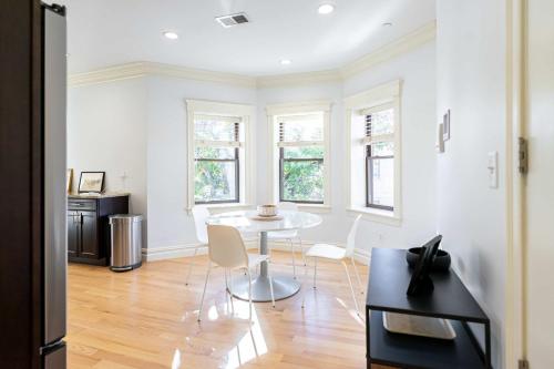 a kitchen with a table and chairs in a room at Brownstone Luxury Penthouse Condo in Boston